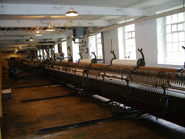 Victorian textile mill interior with automated looms