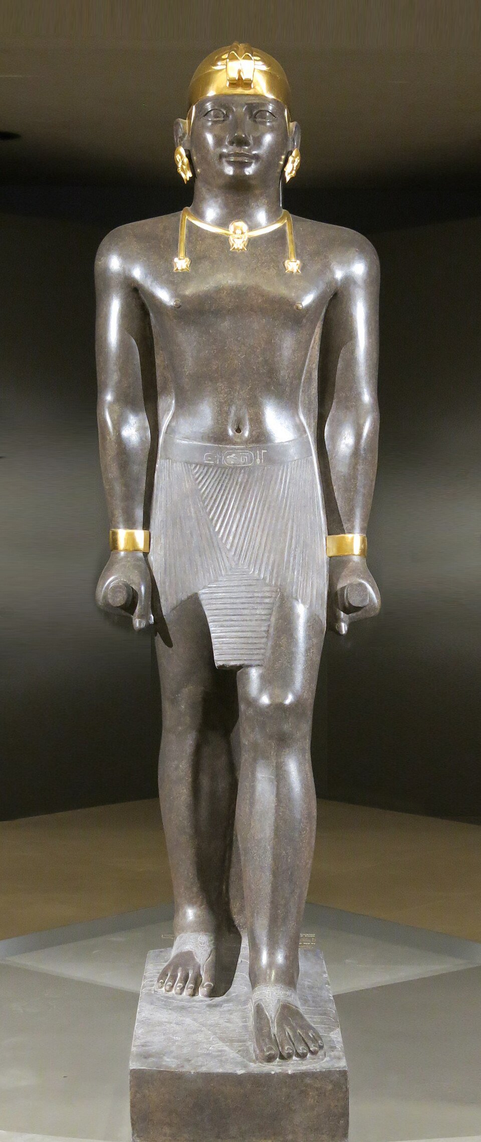 Granite portrait head of Kushite Pharaoh Taharqa wearing the dual uraeus crown
