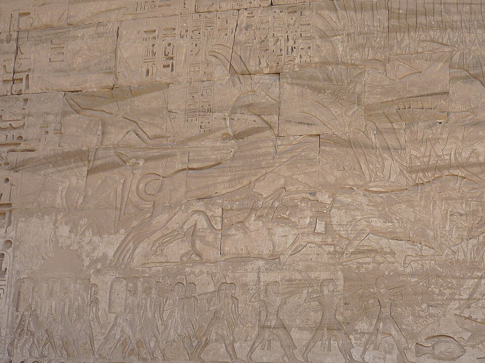 Relief carving of Egyptian war chariots in battle from Medinet Habu