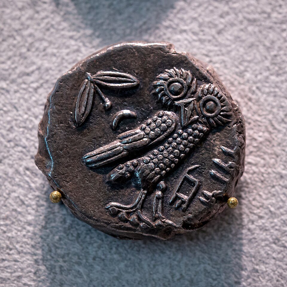 Athenian silver tetradrachm coin showing the owl of Athena and olive sprig